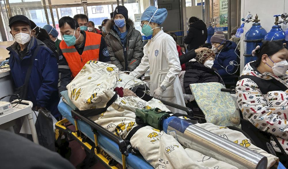En patient får syrgas medan den transporteras på en bår genom en trång akutmottagning på ett sjukhus i Peking, den 2 januari. Foto: Getty Images