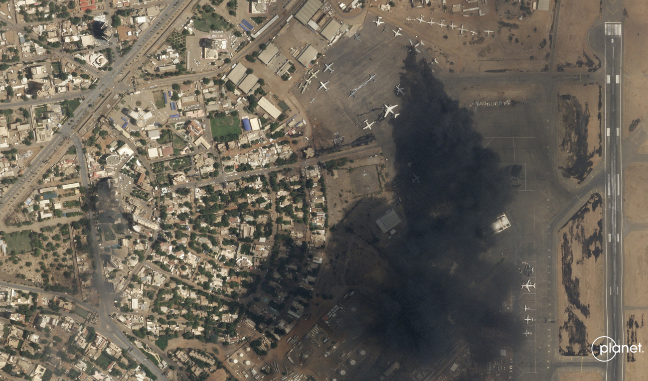 Två flygplan står i brand på Khartums internationella flygplats på söndagen, på denna satellitbild tagen av företaget Planet Labs PBC. Foto: Planet Labs PBC via AP/TT