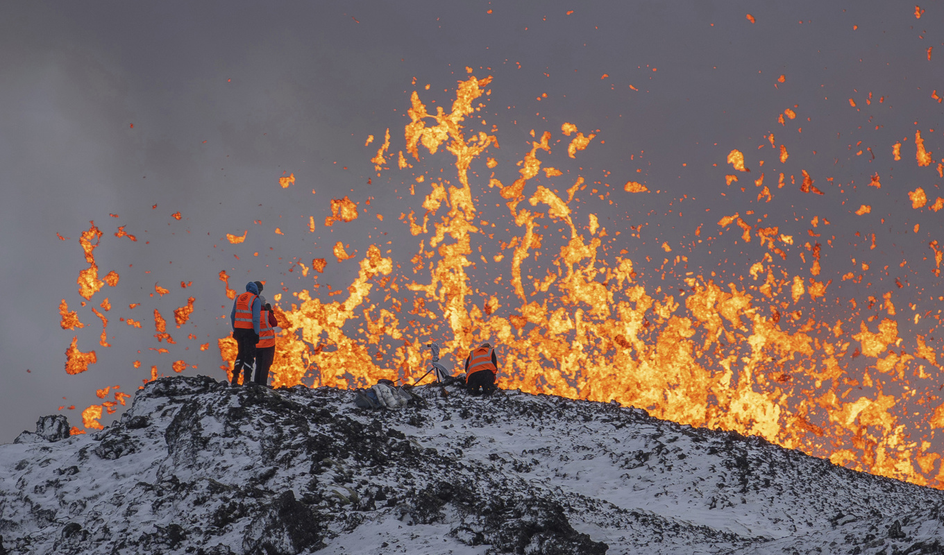 Forskare från Islands universitet i Reykjavik gör mätningar och samlar in prover längs den flera kilometer långa sprickan. Bild från tisdagen. Foto: Marco Di Marco/AP/TT