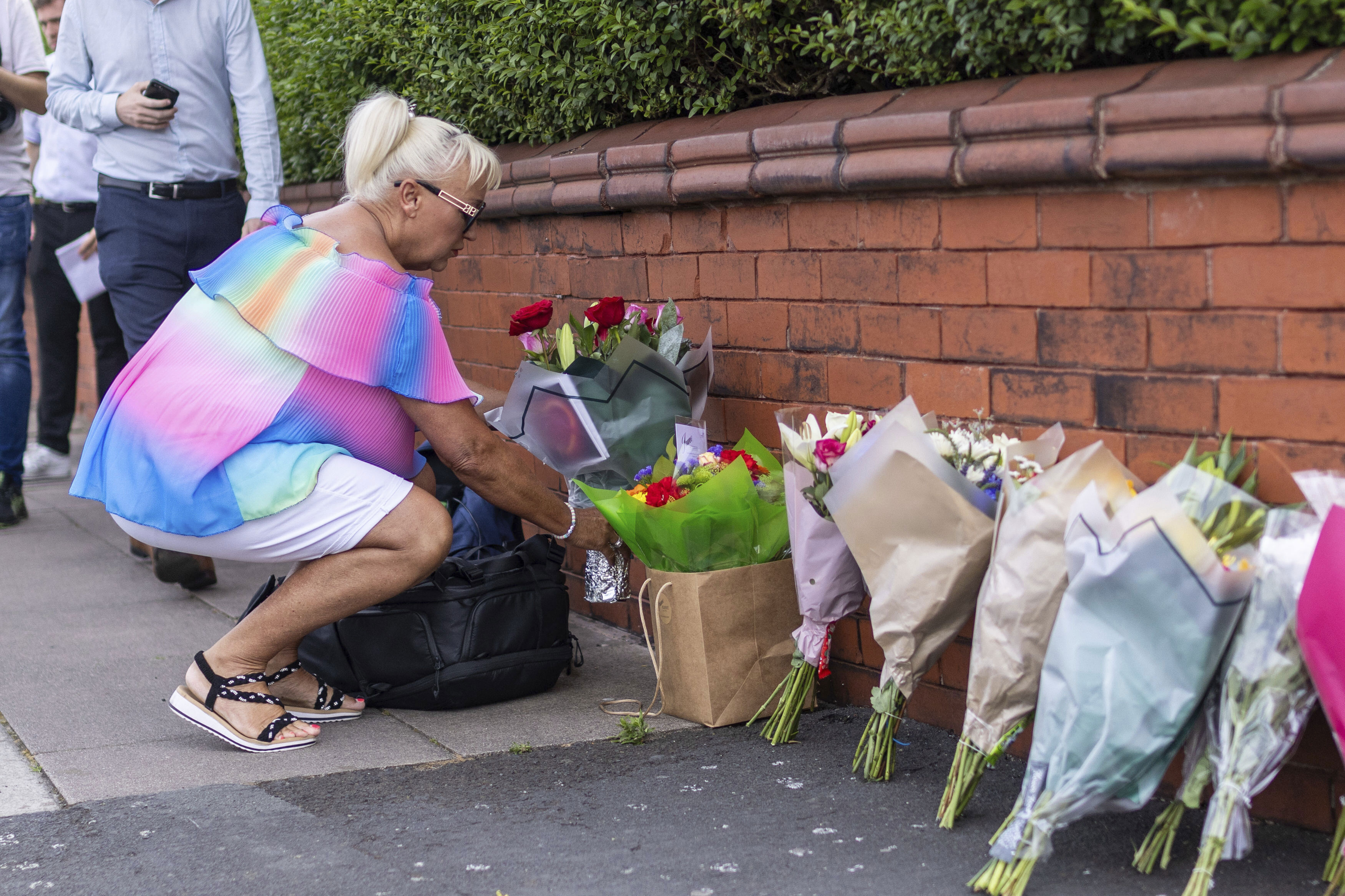 En kvinna lämnar blommor nära platsen där tre barn dödades och flera andra skadades i en knivattack i staden Southport i Storbritannien under måndagen. Foto: James Speakman/AP/TT