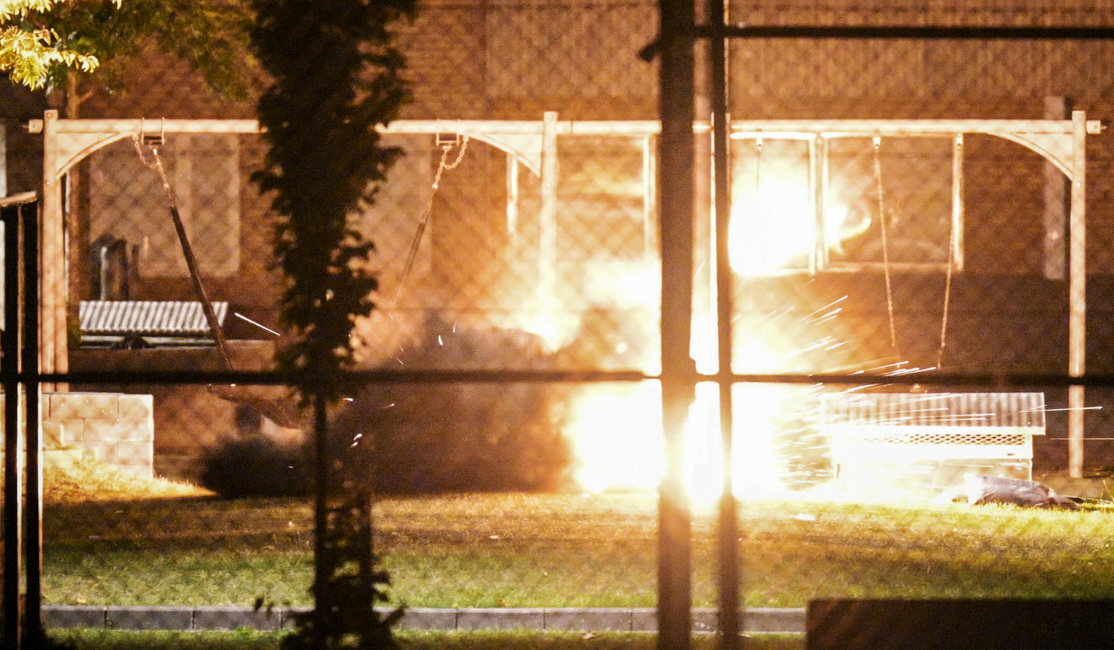 Polisens bombtekniker genomför vid midnatt natten till fredagen en kontrollerad sprängning av den misstänkta handgranaten innanför avspärrningar på Ramels väg på Rosengård i Malmö. Foto: Johan Nilsson/TT