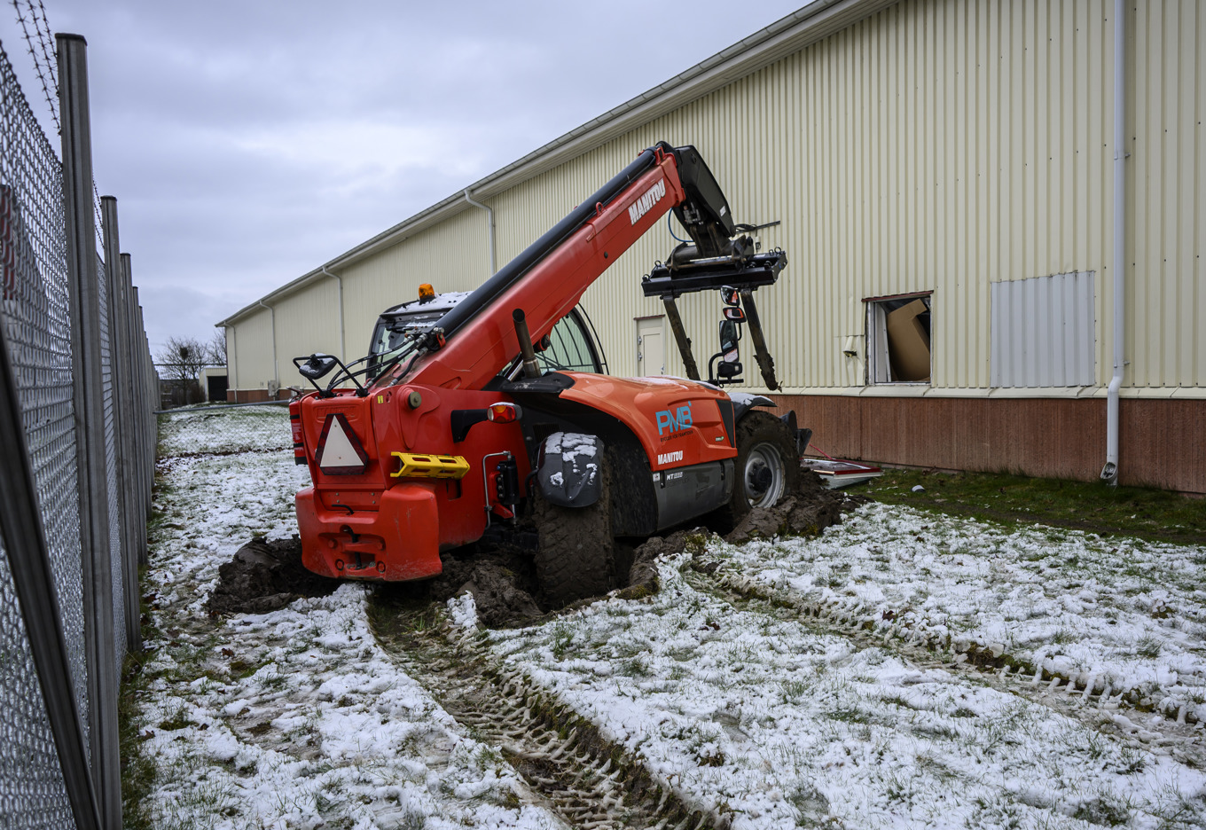 En teleskoplastare och ett trasigt fönster på Migrationsverkets förvar i Åstorp på fredagsmorgonen efter en fritagning under natten. Foto: Johan Nilsson/TT