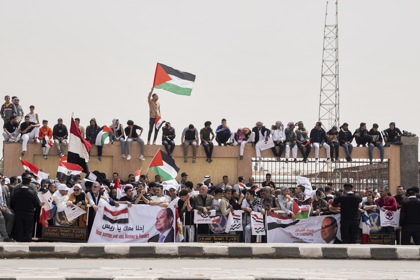 Palestinska och egyptiska flaggor vajar när Egyptens president Abd al Fattah al-Sisi och gästande franske presidenten Emmanuel Macron reser mot staden El-Arish. Foto: Mohammed Arafat/AP/TT