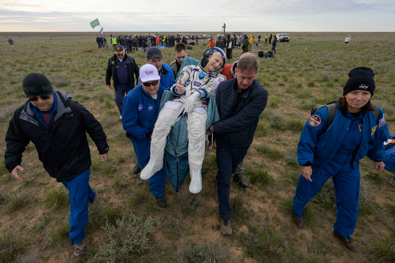 Astronauten Don Pettit ger tummen upp när han bärs bort från landningsplatsen i Kazakstan. Foto: Bill Ingalls/AP/TT