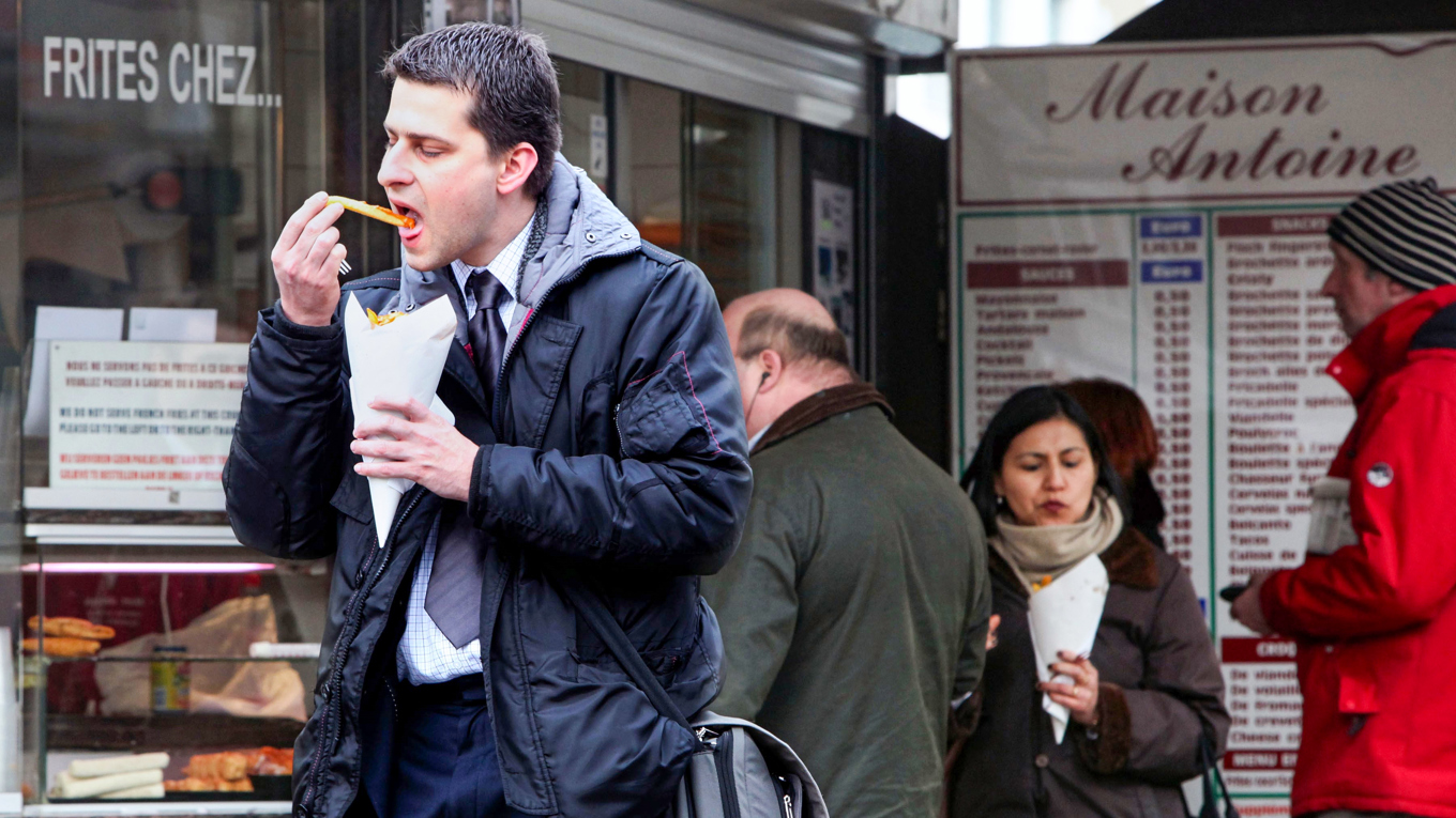 Belgare smaskar vid klassiska pommes frites-kiosken Maison Antoine i centrala Bryssel. Arkivbild. Foto: Geert Vanden Wijngaert/AP/TT