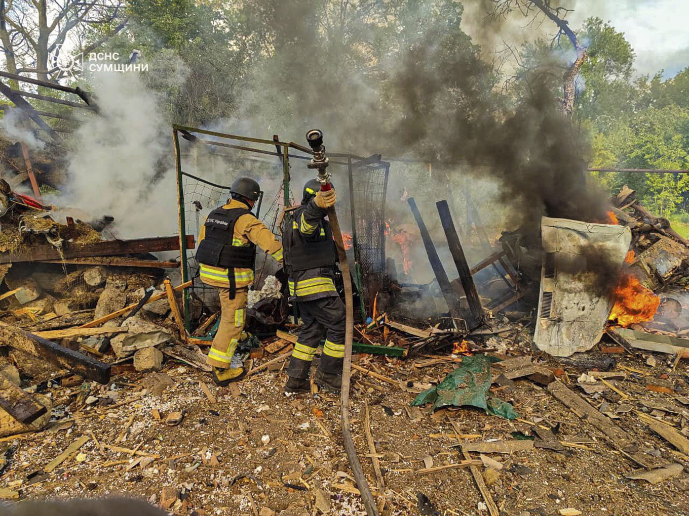 Ukrainsk räddningspersonal släcker en brand efter en rysk flygräd mot Sumyregionen i nordöstra Ukraina. Foto: AP/TT