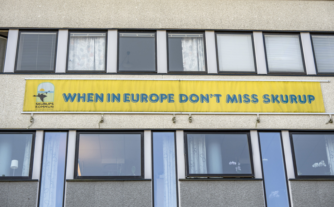 "When in Europe don’t miss Skurup" - välkänd kommunslogan på kommunhuset i Skurup i september 2025. Till vänster i bild syns den logotyp med Nils Holgersson som en majoritet i Skurup röstat för. Arkivbild. Foto: Johan Nilsson / TT