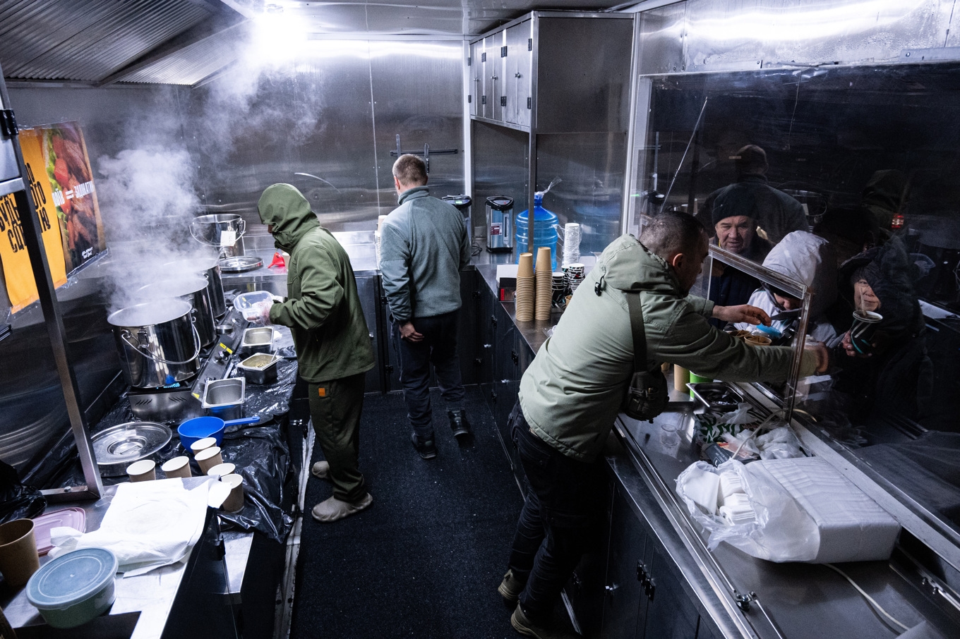 Krigsveteraner serverar gratis varm mat till invånare som drabbats av strömavbrott i ett bostadsområde i Kiev under veckan. Foto: Danylo Antoniuk/AP/TT