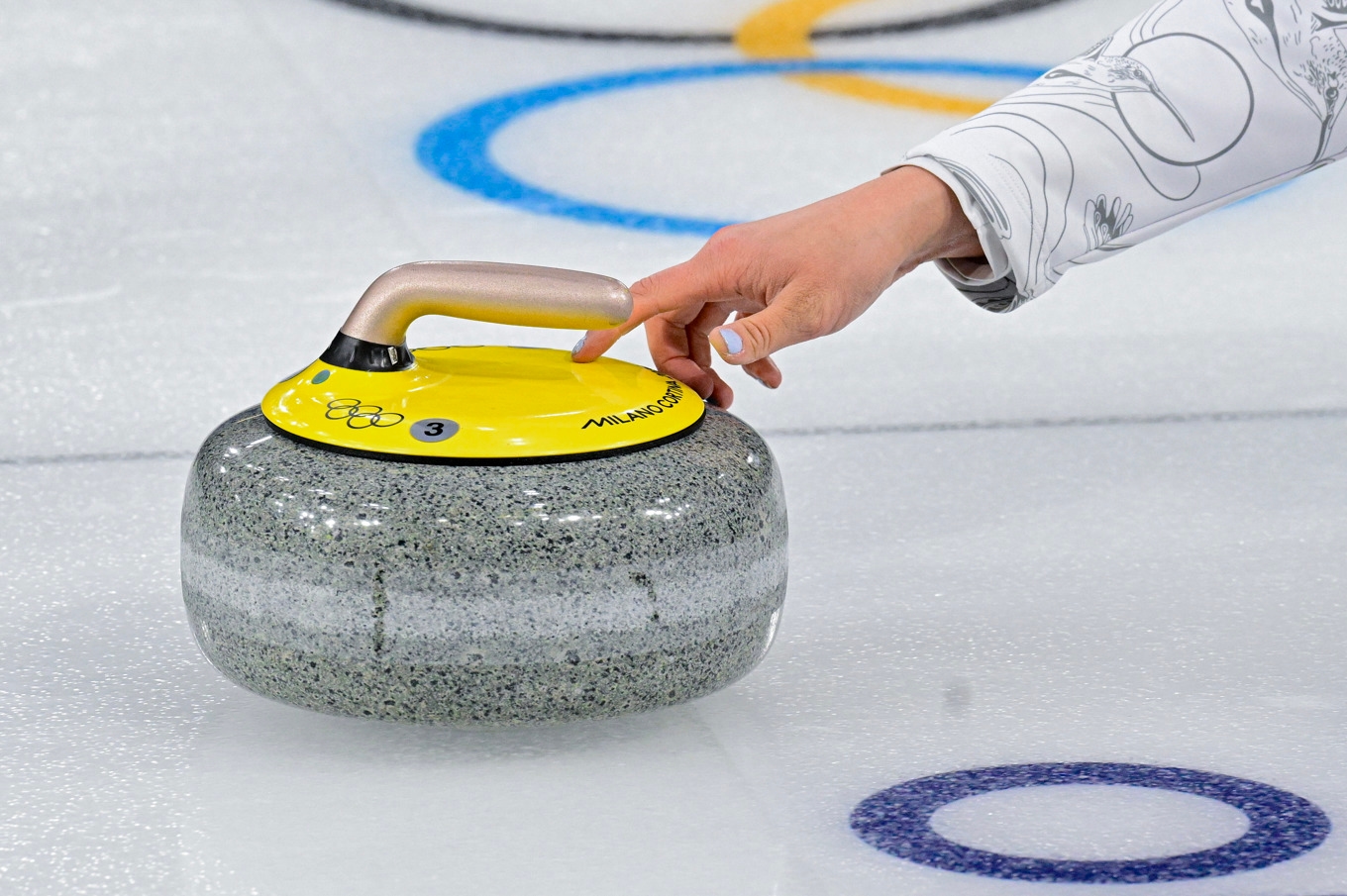 Inzoomad bild på Kanadas Rachel Homan som skjuter iväg en sten under damernas gruppspelsmatch, omgång 9, mellan Sverige och Kanada i OS-curlingen i Cortina. Foto: Jonas Ekströmer/TT