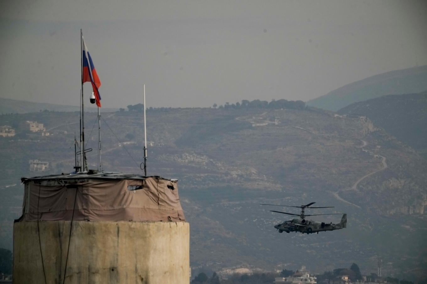En rysk helikopter flyger över flygbasen Khmeimim, sydost om staden Lakakia i västra Syrien. Arkivbild. Foto: Leo Correa/AP/TT