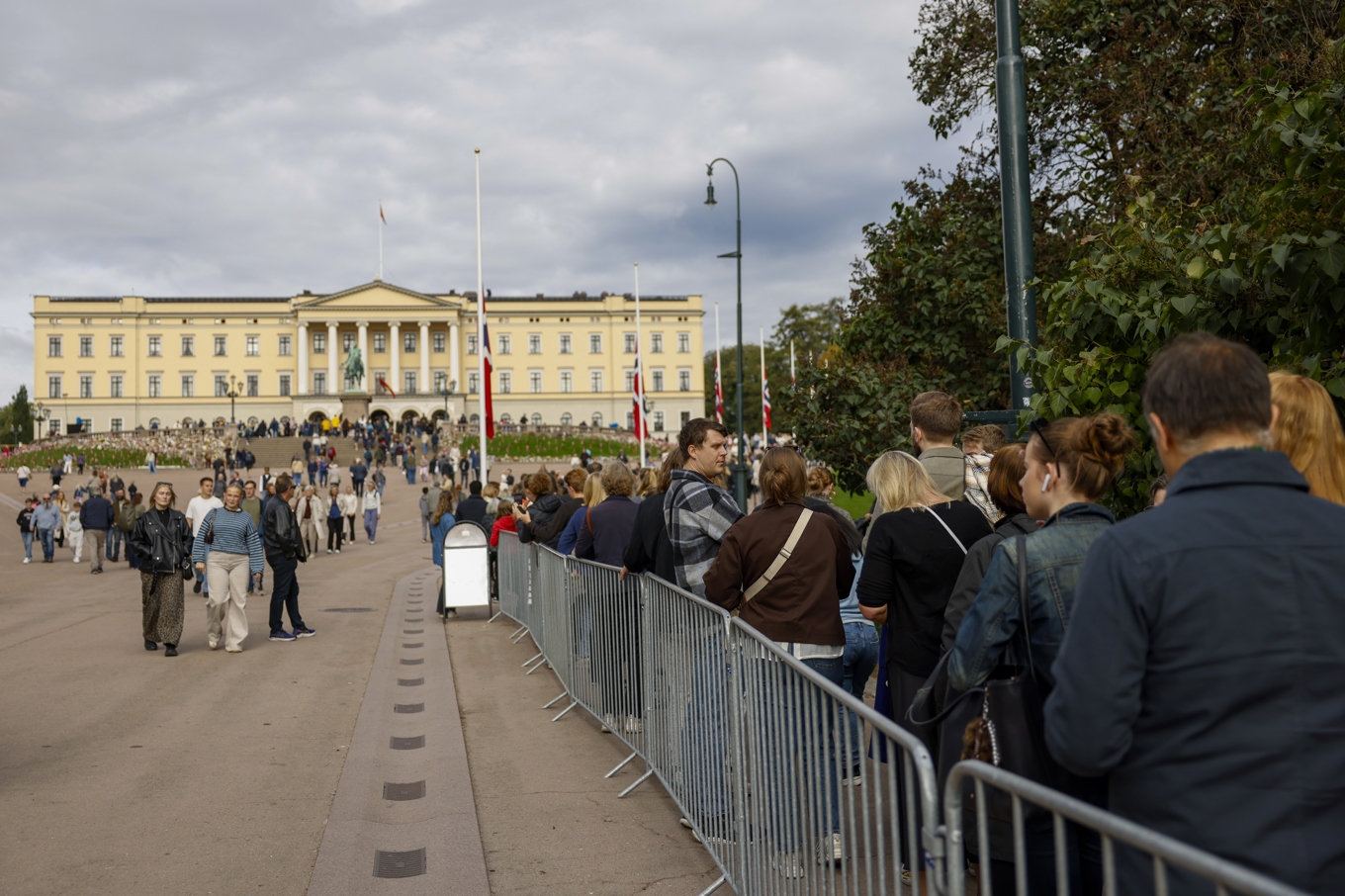 På lördagen sträcker sig en lång kö ned för Slottsbacken i Oslo då allmänheten är där för att ta avsked av den avlidne kungen. Foto: Hanna Johre/NTB/TT