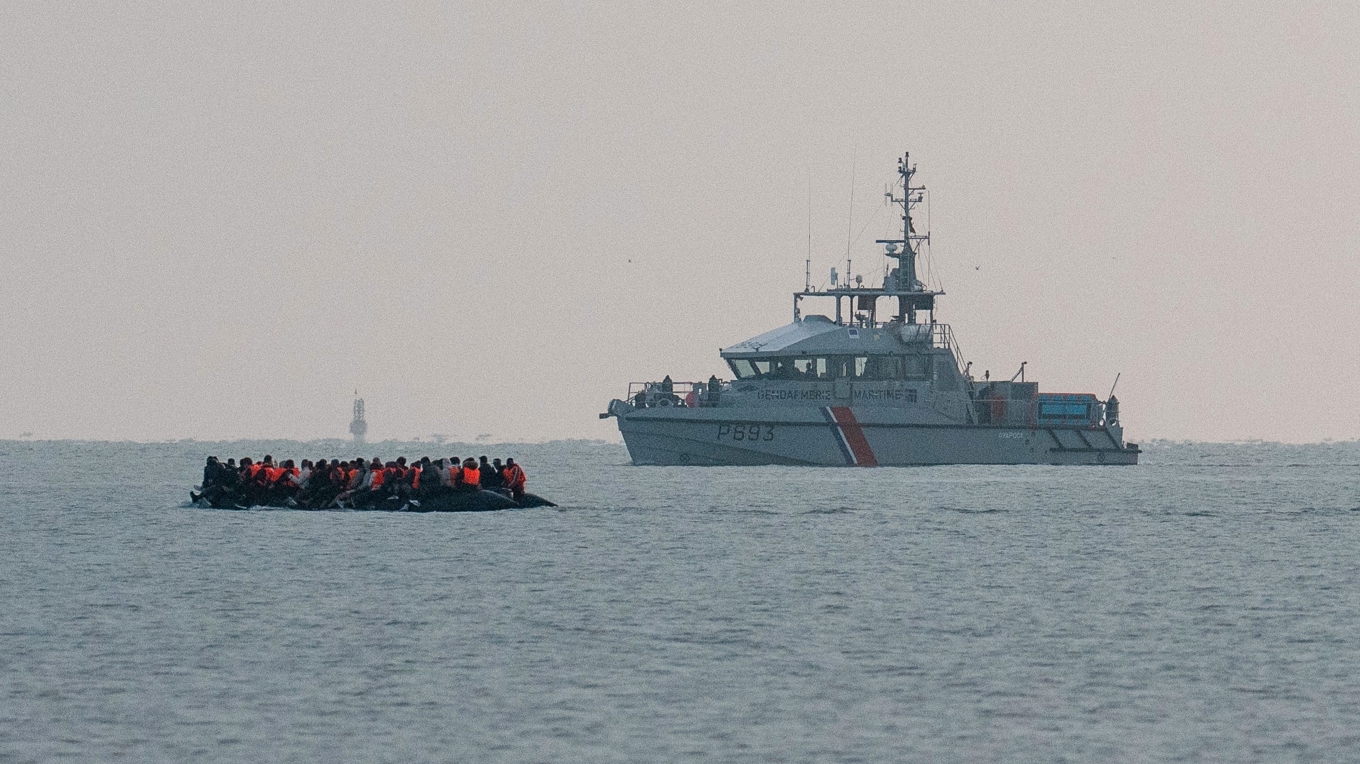 En båt med migranter passerar ett franskt kustbevakningsfartyg när det seglar in i Engelska kanalen den 31 maj i Gravelines, Frankrike. Foto: Carl Court/Getty Images